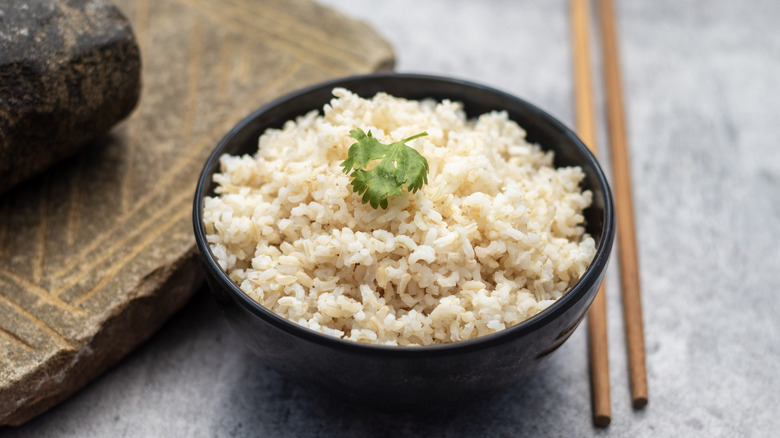 cooked brown rice in black bowl
