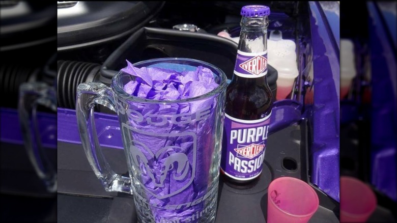 Everclear Purple Passion bottle beside a beer glass mug with purple napkin stuffed inside