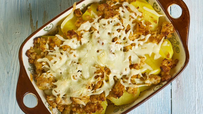 an overhead view of a casserole dish filled with scalloped potatoes and ground beef topped with melted cheese