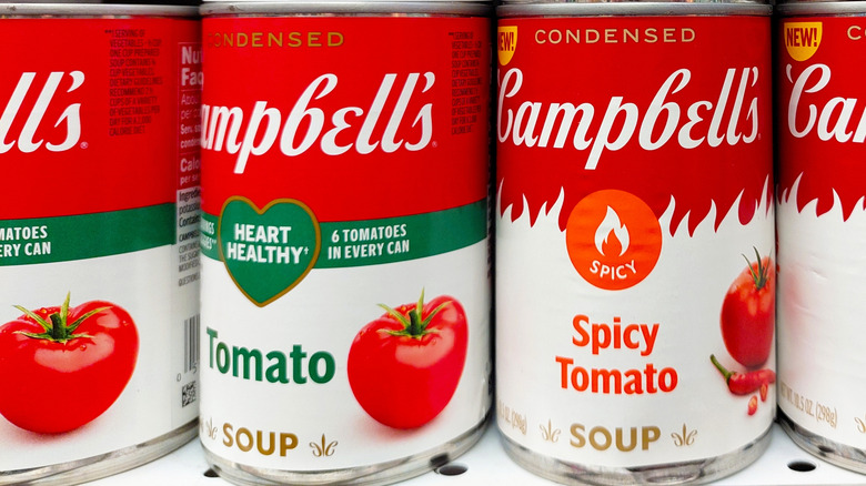 cans of Campbell's tomato soup on a store shelf