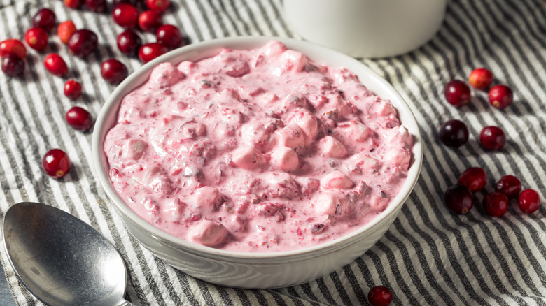 A bowl of pink lady salad with marshmallows and cranberries