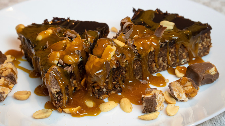 Slices of Snickers cake on a plate.