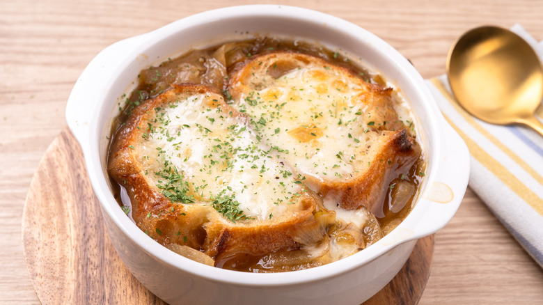 Crock of onion soup with spoon