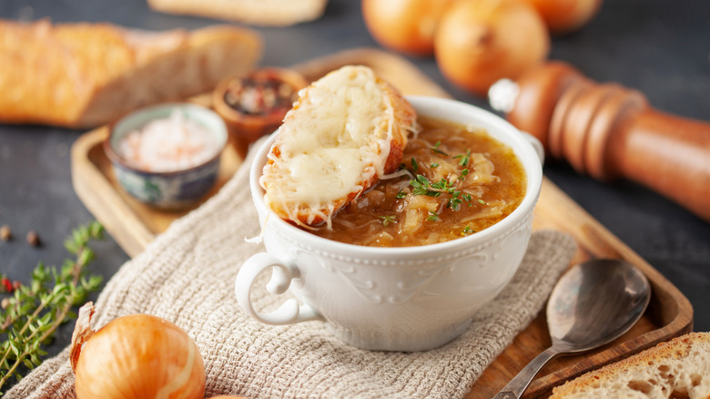 Crock of French onion soup with spoon
