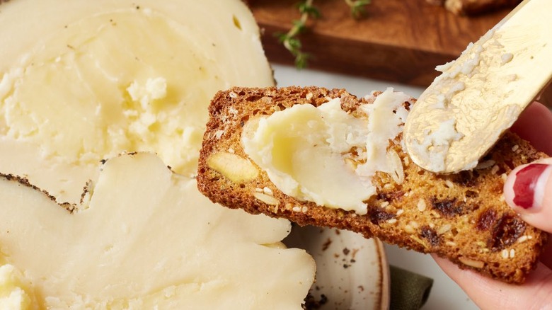 Burrino pepato being spread on bread