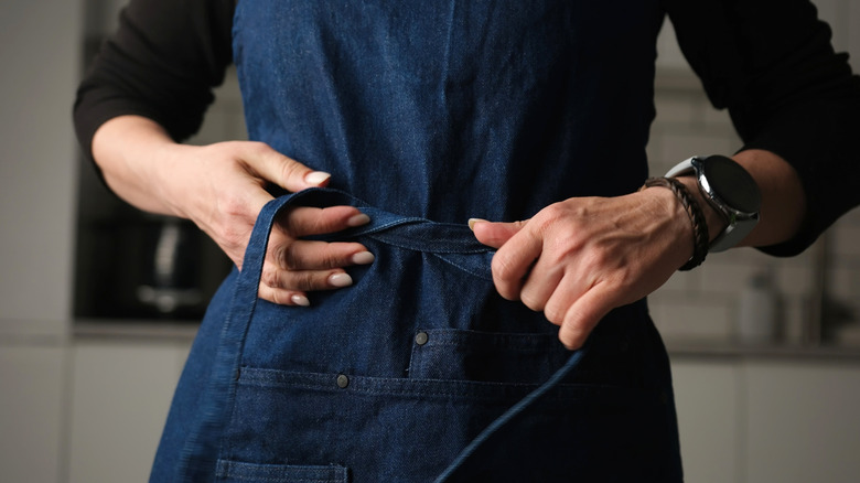 Chef fastening an apron