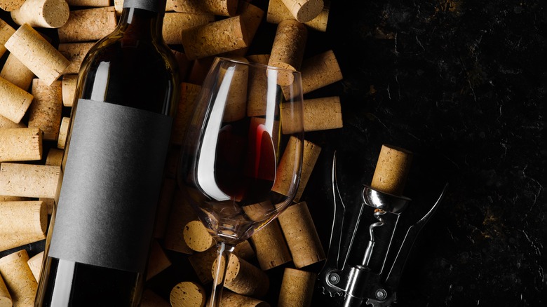 wine bottle with glass and corks