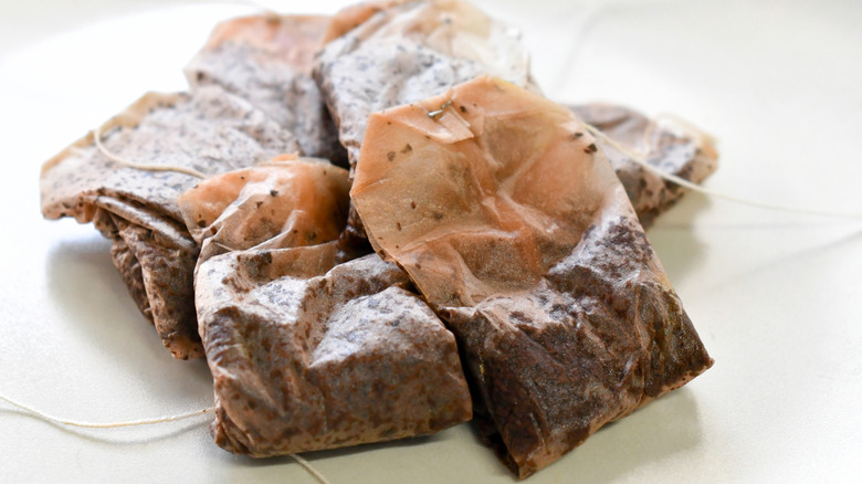 Used tea bags on a plate