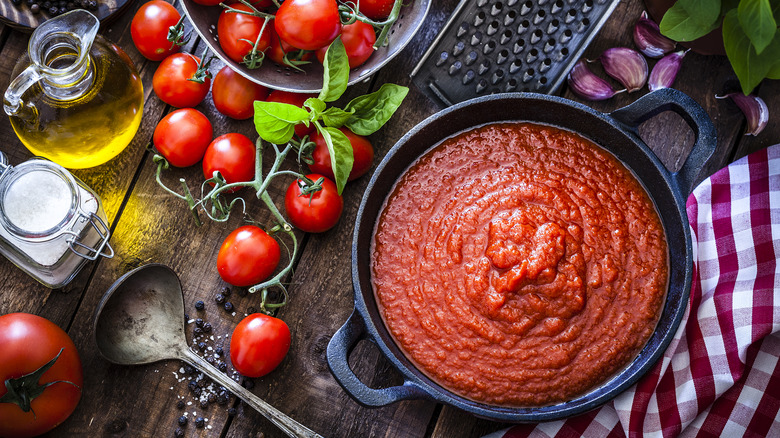 Bowl of marinara sauce with tomatoes, olive oil, salt, pepper