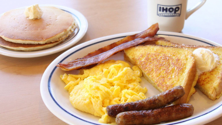 IHOP meal with pancakes, scrambled eggs, bacon, french toast, and sausage