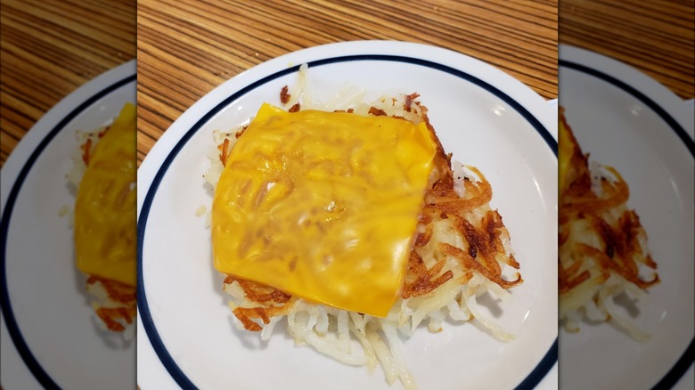 Plate of hash browns with cheese