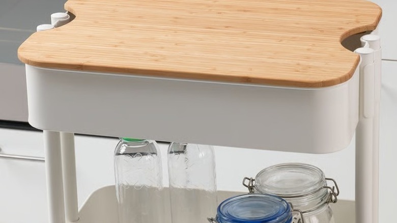 A HÖGSMA chopping board fitted on a RASKOG utility cart from IKEA