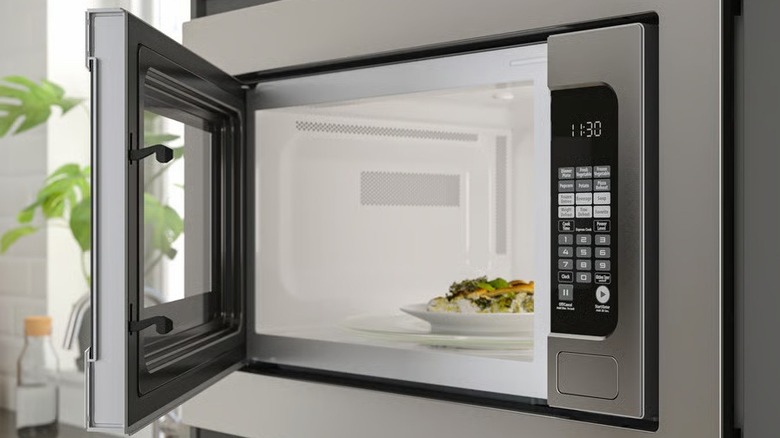 Close-up of the Äskebo built-in microwave with an open door and food shown inside