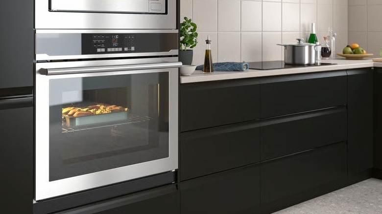 The Vaskarbo wall oven shown fitted into a modern kitchen with food cooking inside