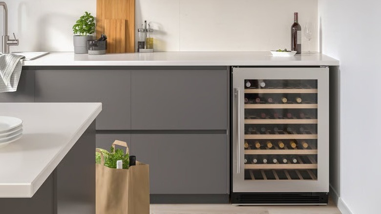The Numrerad 52-bottle wine cooler installed in a kitchen and filled with bottles