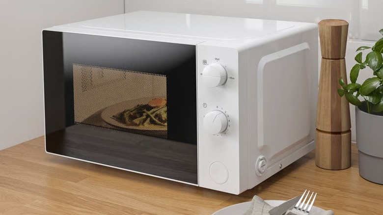 The Tillreda microwave oven shown on a kitchen counter with food cooking inside