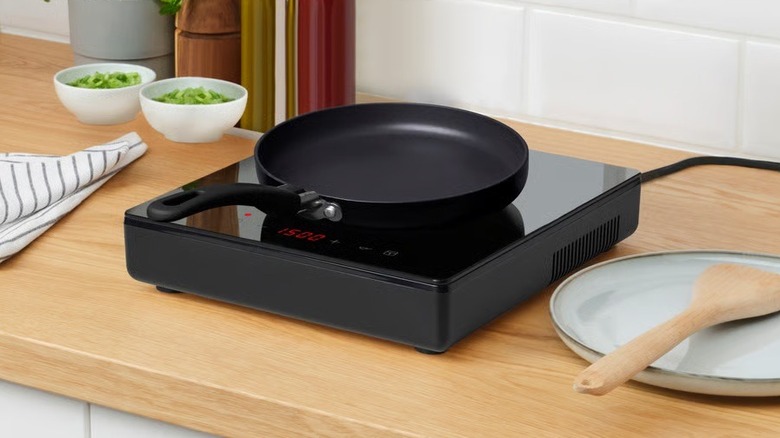 The Tillreda portable induction cooktop placed on a kitchen counter with an empty pan resting on it