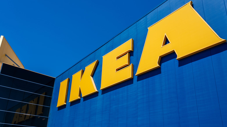 Close-up of a large IKEA sign outside one of its stores in front of a bright blue sky