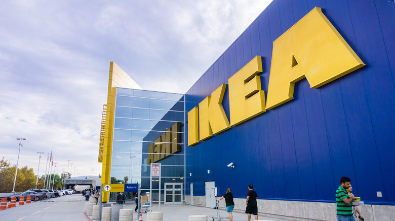 Outdoor shot of an Ikea store showing the large signage and customers going in and out
