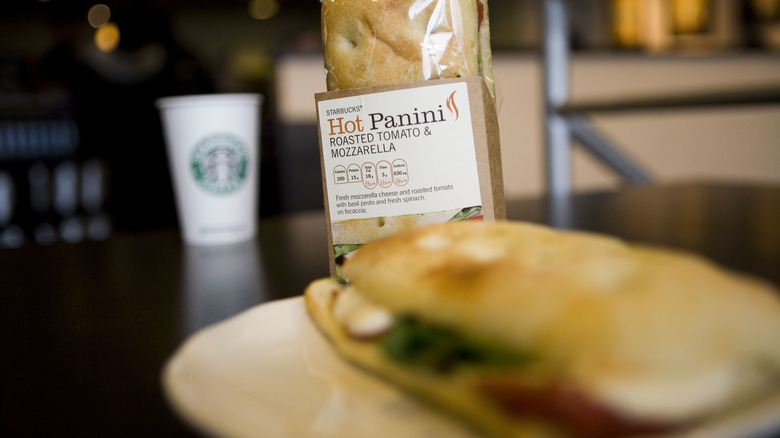 Starbucks panini on a white plate with a packaged version behind it
