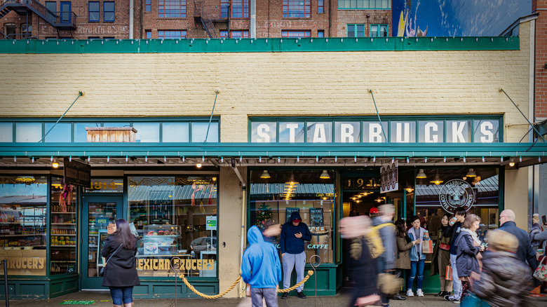 Starbucks Seattle location with people waiting outside