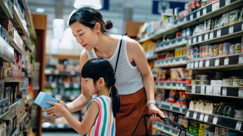 Two people shopping in a grocery store