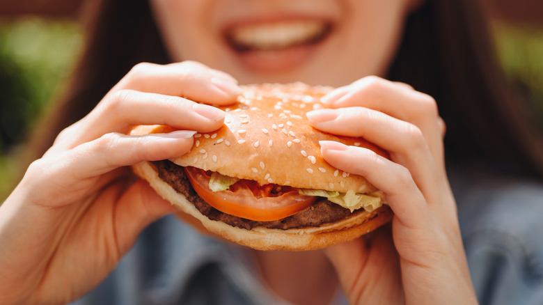 Woman eating fast food burger