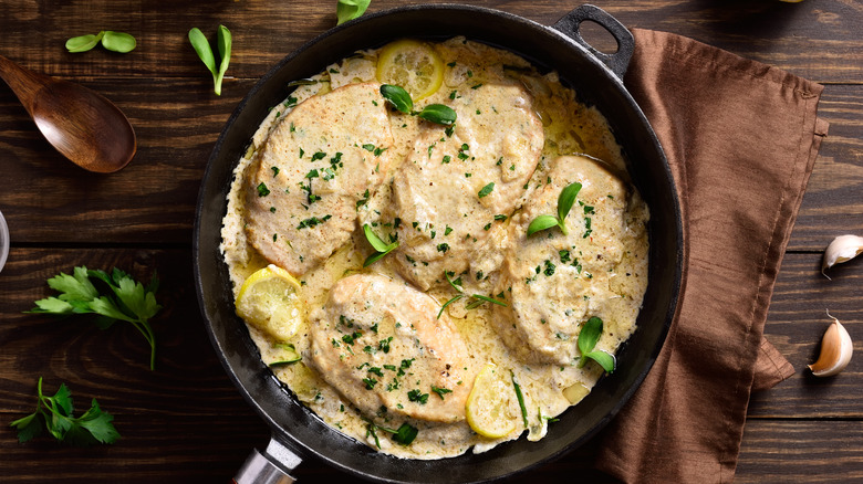chicken with creamy sauce in skillet