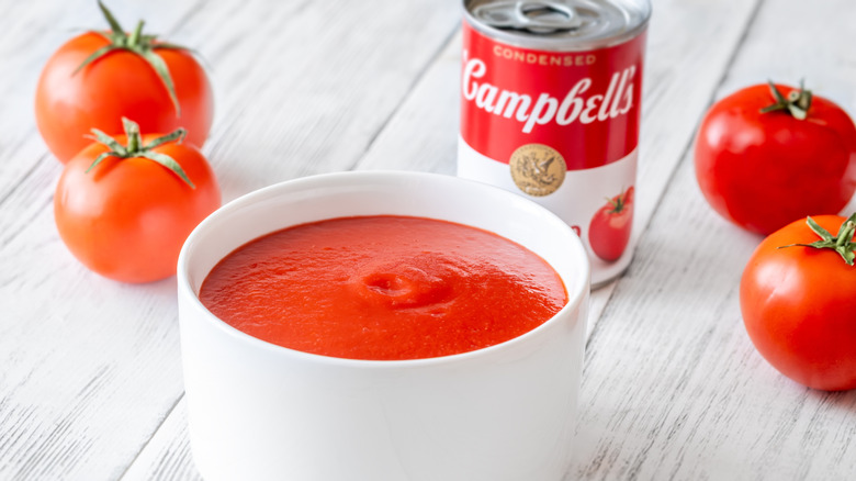 can of tomato soup with liquid in bowl