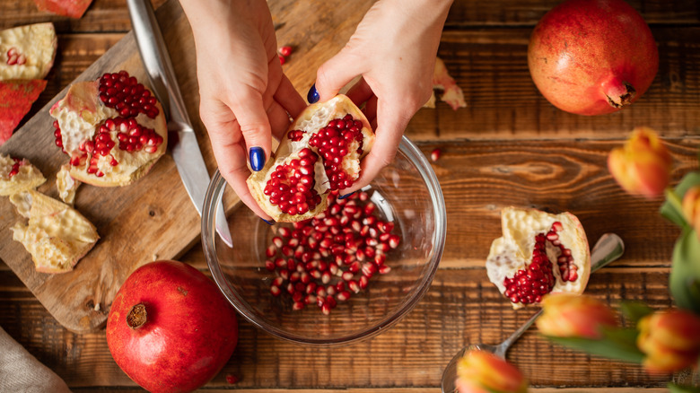 Seeding pomegranate into bowl