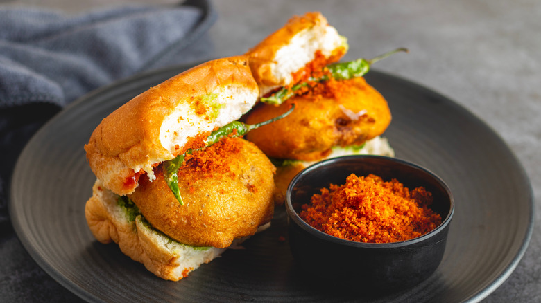 Vada pav Bombay sandwich with chutney on a gray plate