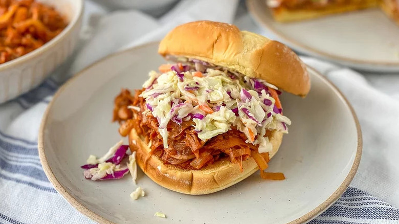 Barbecue jackfruit sandwich with coleslaw on a white plate