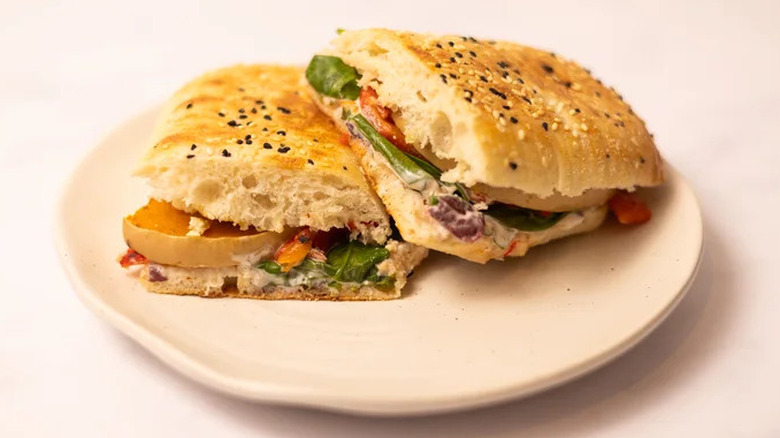 Cumin-roasted squash and feta panini on a white plate