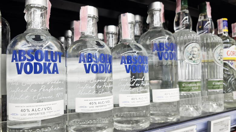 Store shelf displaying Absolut Vodka bottles alongside other brands