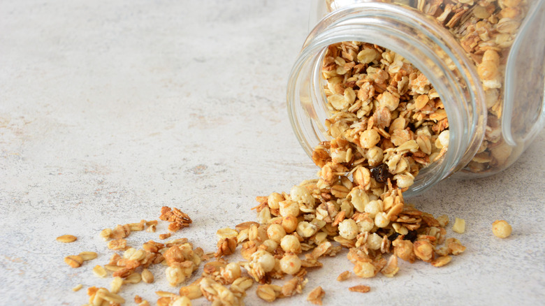 Granola spilling from glass jar