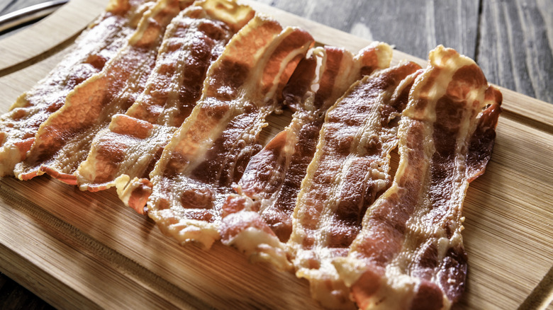 Cooked bacon on wooden board