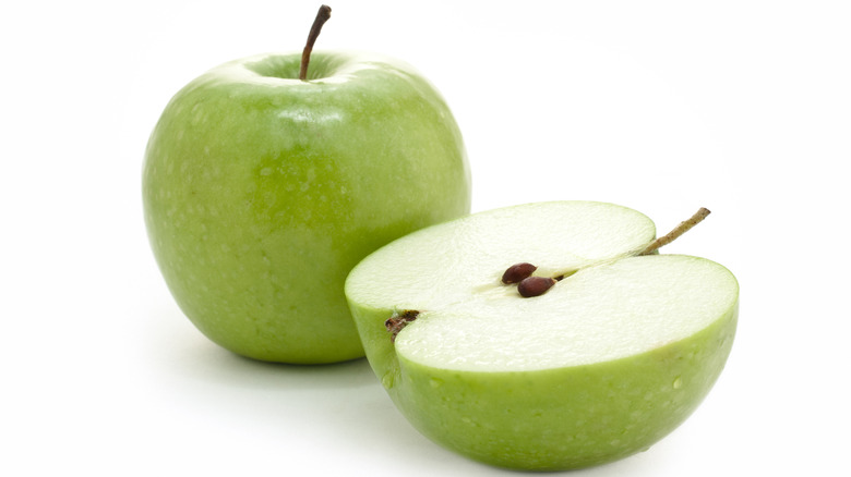 Whole and halved Granny Smiths