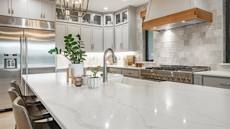View of kitchen with white granite countertops