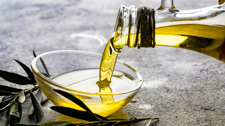 pouring olive oil into small dish