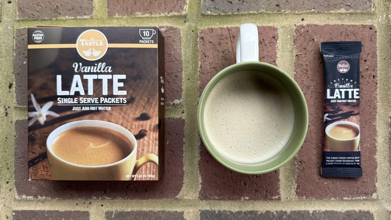 Mug of Tastlé instant vanilla latte with box and stick