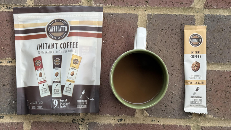 Mug of Caffelatto vanilla latte with packaging and stick