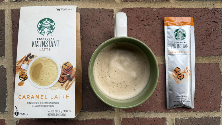 Mug of Starbucks VIA instant caramel latte with box and stick