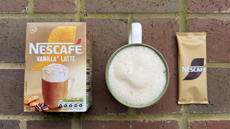 Mug of Nescafé Gold vanilla latte with box and stick