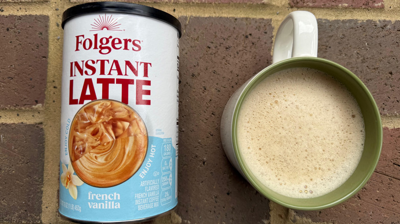 Mug of Folger's French vanilla latte with cylindrical container