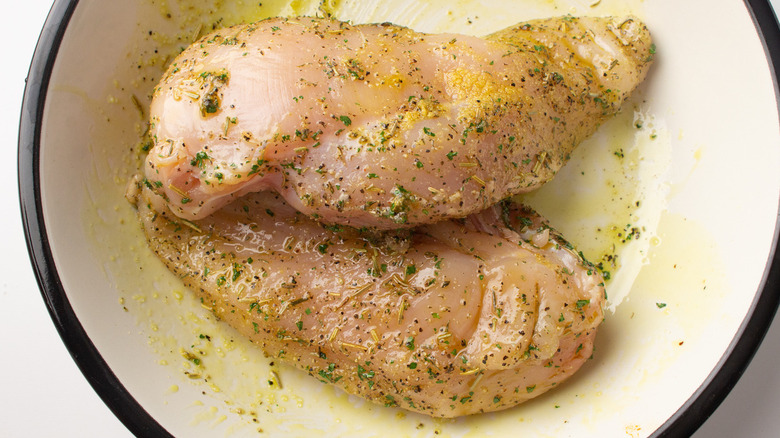 seasoned chicken breasts in pan