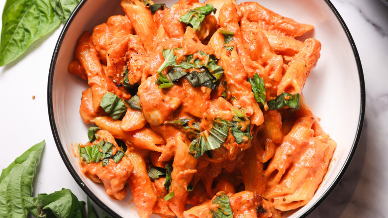 Penne pasta in creamy tomato sauce in bowl