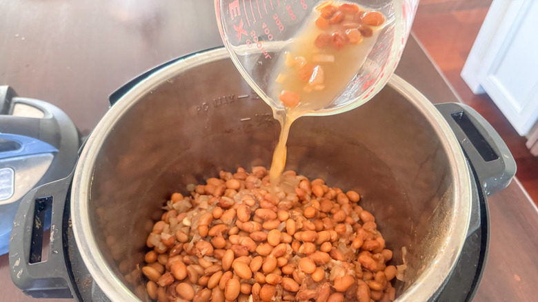 adding beans to pot