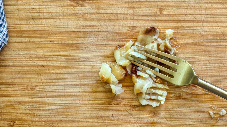 fork mashing garlic