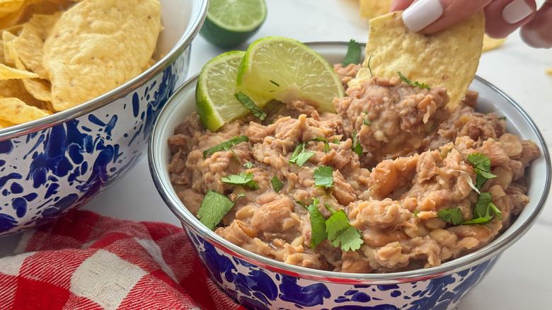 hand dipping chip into dip