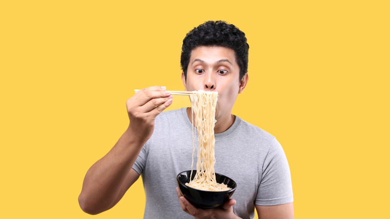 Person eating ramen